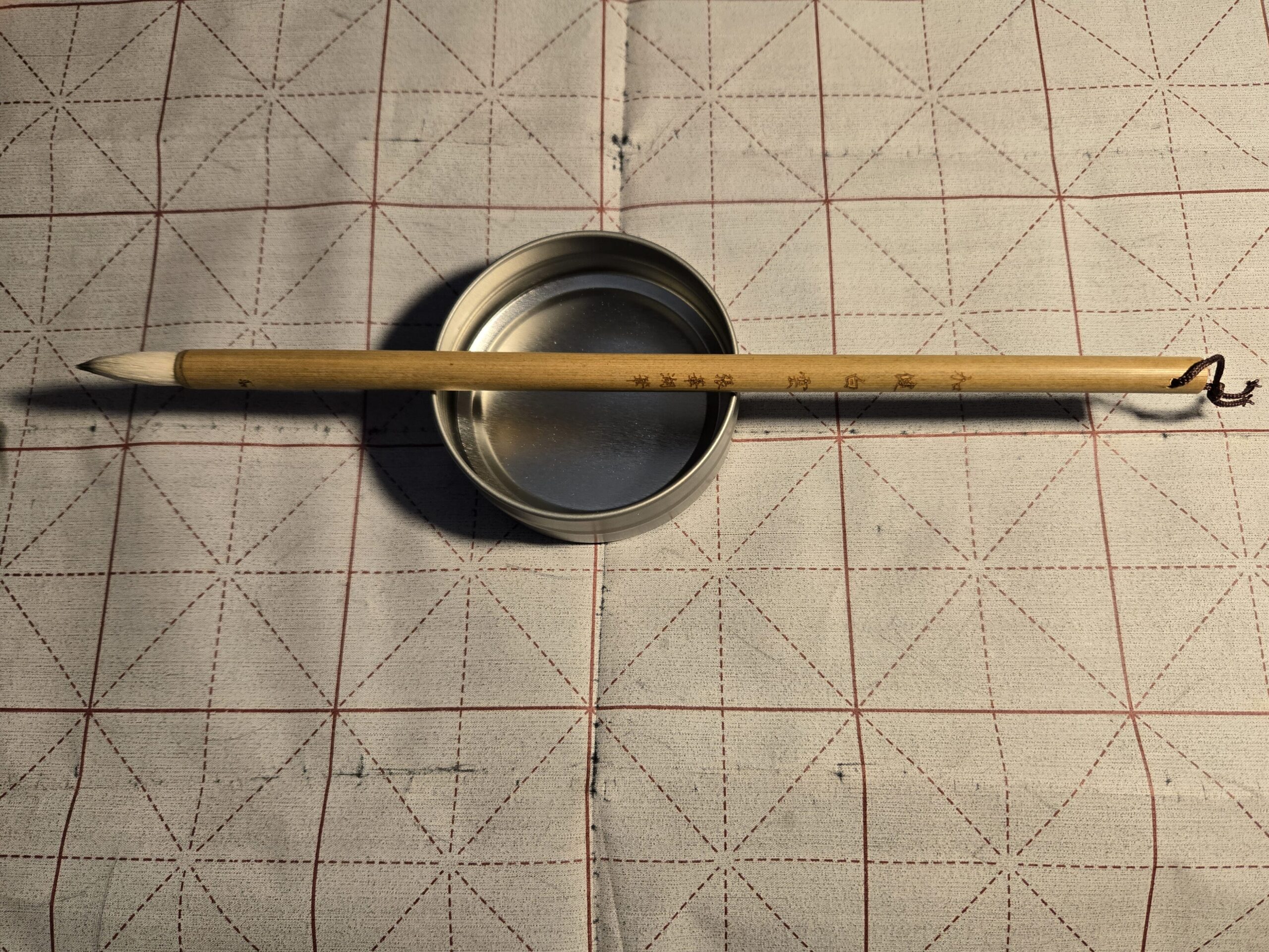 Calligraphy brush and mat, with tin of water