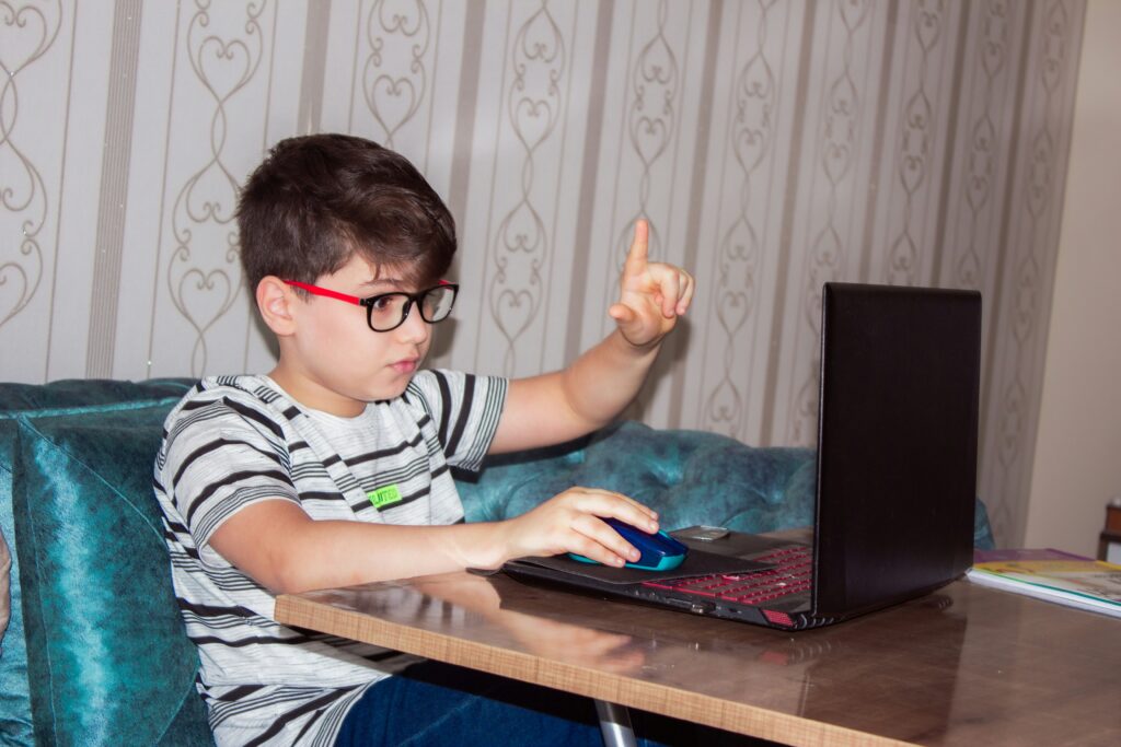 Kid at home on a laptop.